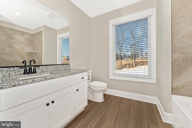 full bathroom with plenty of natural light, wood finished floors, baseboards, and a shower