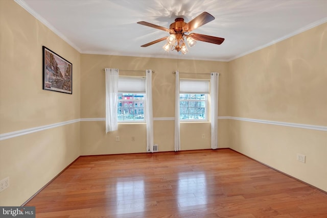 spare room with ceiling fan, wood finished floors, and ornamental molding