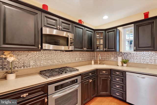 kitchen with light countertops, tasteful backsplash, and appliances with stainless steel finishes