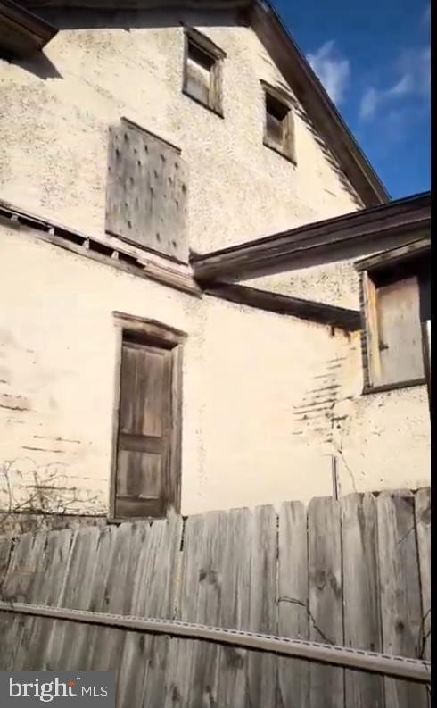 view of side of home with stucco siding