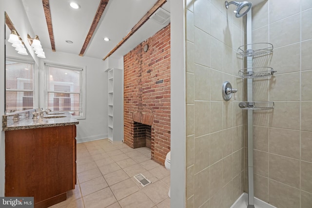 full bath featuring visible vents, toilet, a tile shower, a fireplace, and vanity