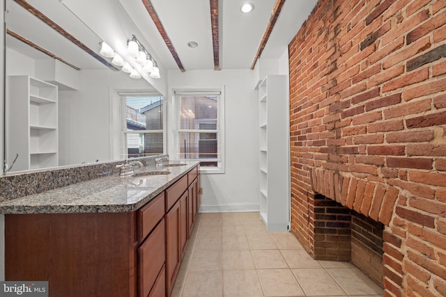 bathroom featuring built in features, baseboards, brick wall, and tile patterned flooring