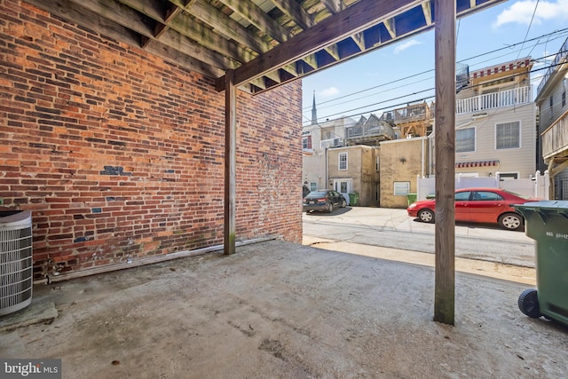 view of patio / terrace featuring a residential view and central AC unit