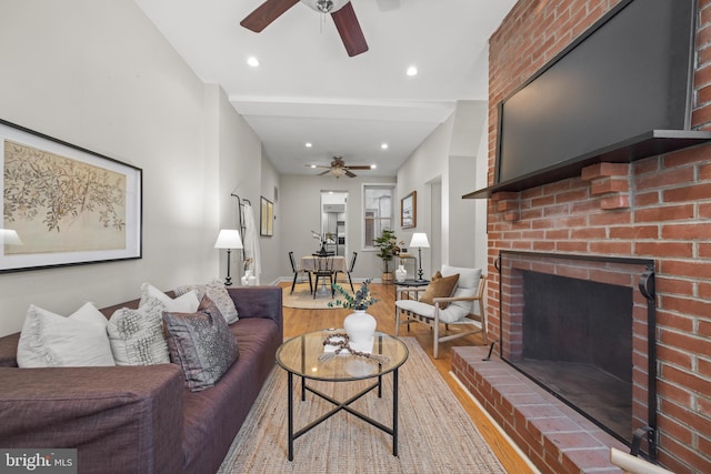 living room featuring recessed lighting, a fireplace, a ceiling fan, and wood finished floors