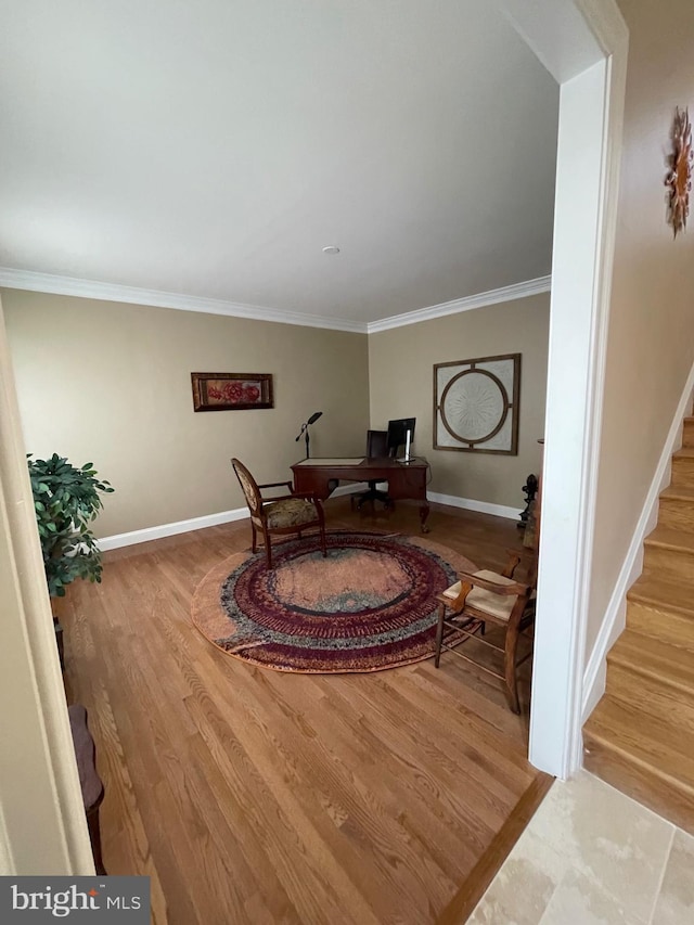 interior space featuring crown molding, stairway, wood finished floors, and baseboards