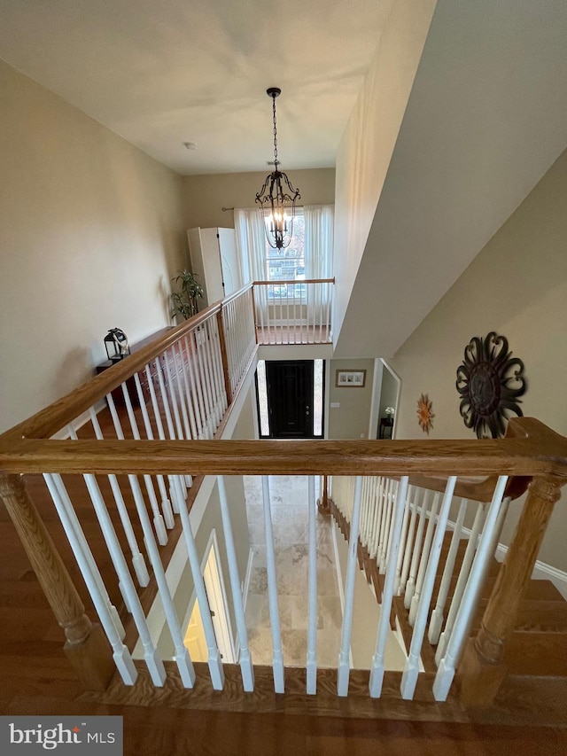 stairs with a chandelier