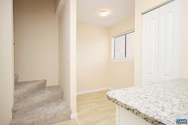 interior space featuring baseboards and wood finished floors