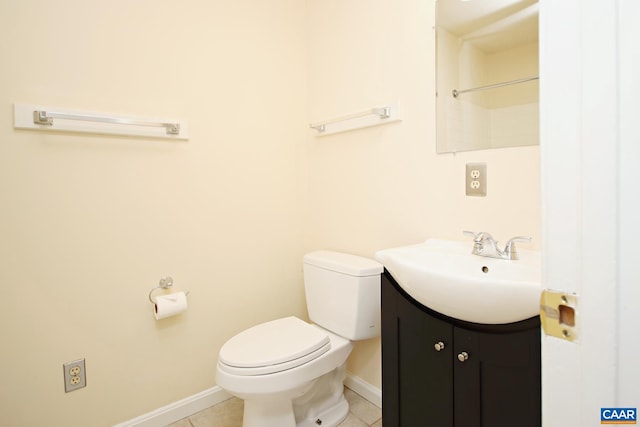 bathroom featuring tile patterned floors, baseboards, toilet, and vanity