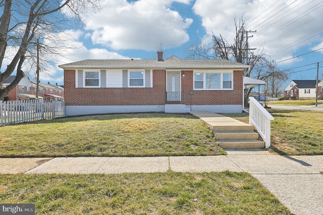 view of front of property with brick siding, a chimney, a front yard, and fence