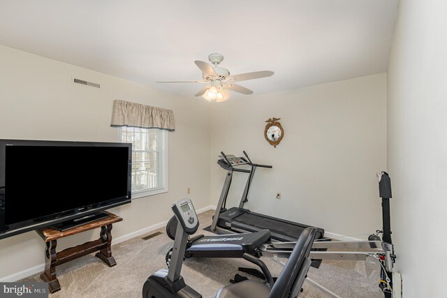 workout area featuring light carpet, baseboards, visible vents, and ceiling fan