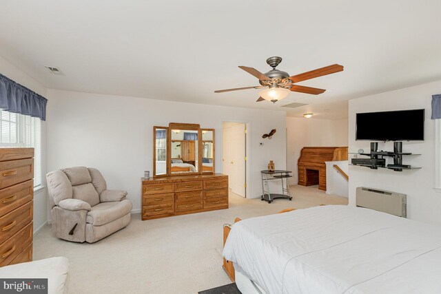 bedroom with ceiling fan, visible vents, and light carpet