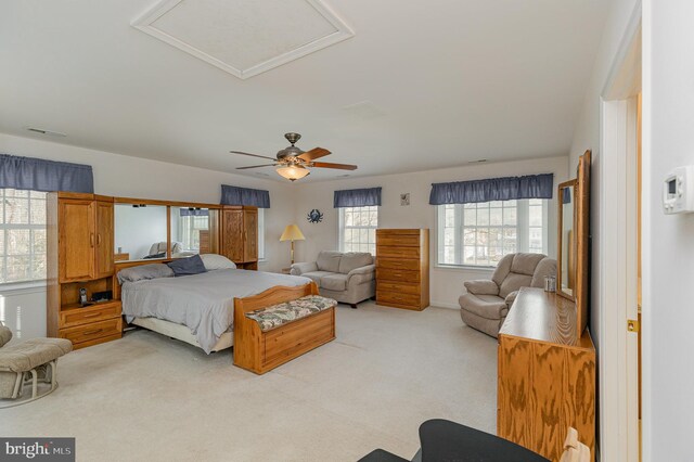 bedroom featuring light carpet and a ceiling fan