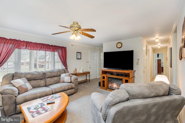 living room with a ceiling fan, ornamental molding, and light colored carpet