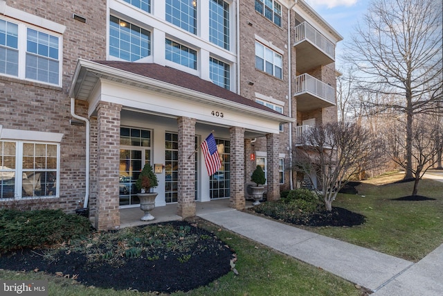 view of exterior entry with brick siding