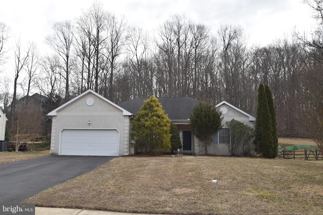 single story home with a front lawn, an attached garage, central AC, and driveway