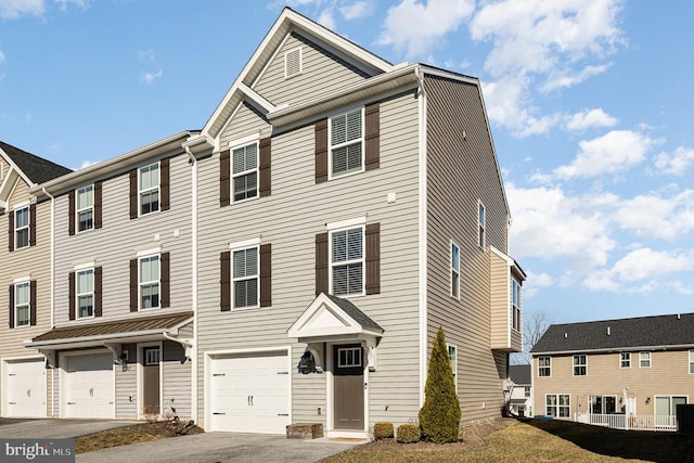 multi unit property featuring an attached garage and driveway