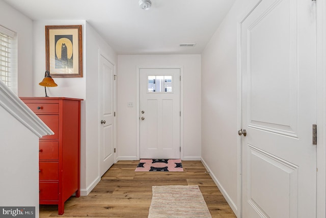 entryway with visible vents, baseboards, and light wood finished floors