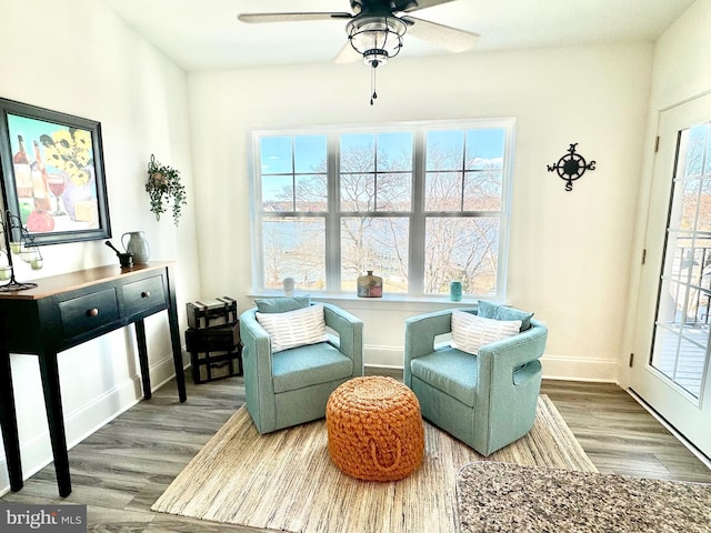 sitting room featuring ceiling fan, baseboards, and wood finished floors