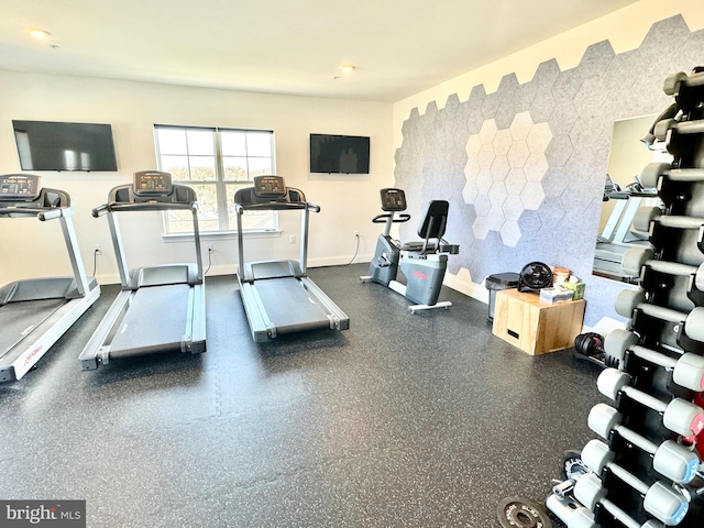 workout area with baseboards and an accent wall