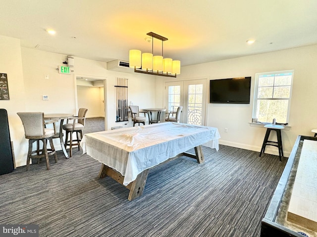 recreation room with dark colored carpet, french doors, and a wealth of natural light