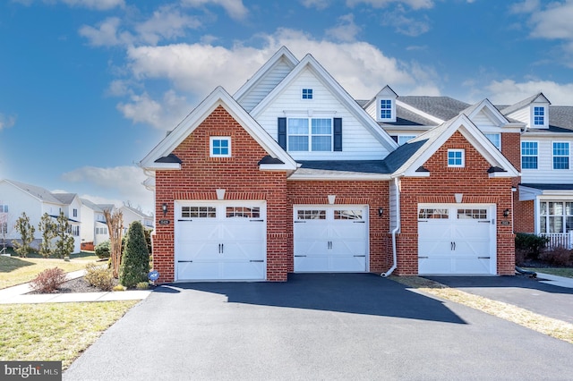 view of front of home with a garage, brick siding, driveway, and roof with shingles