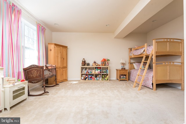 bedroom with baseboards and light carpet