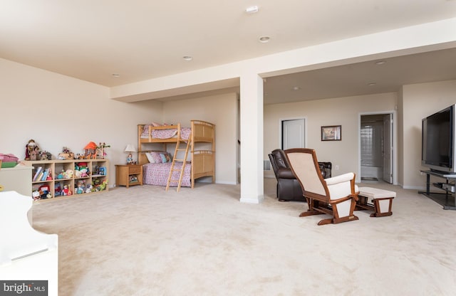 sitting room featuring carpet flooring and baseboards