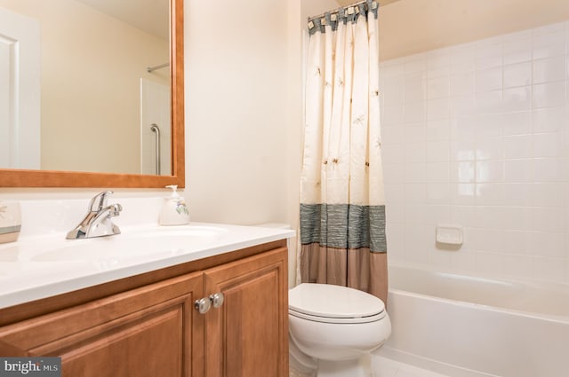 full bath with tile patterned flooring, toilet, vanity, and shower / bath combo