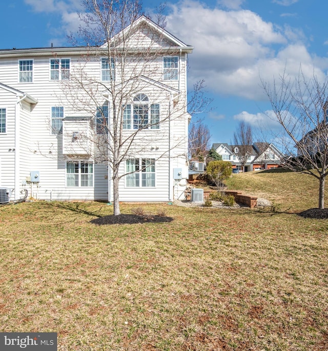 rear view of property featuring a yard