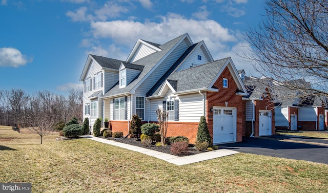 view of property exterior with brick siding, a shingled roof, aphalt driveway, a yard, and an attached garage