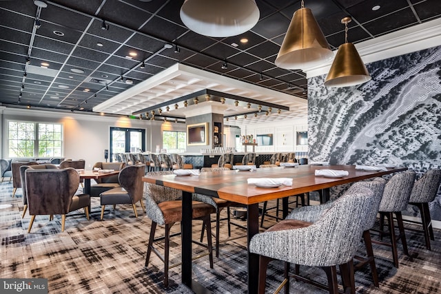 carpeted dining area featuring visible vents and rail lighting