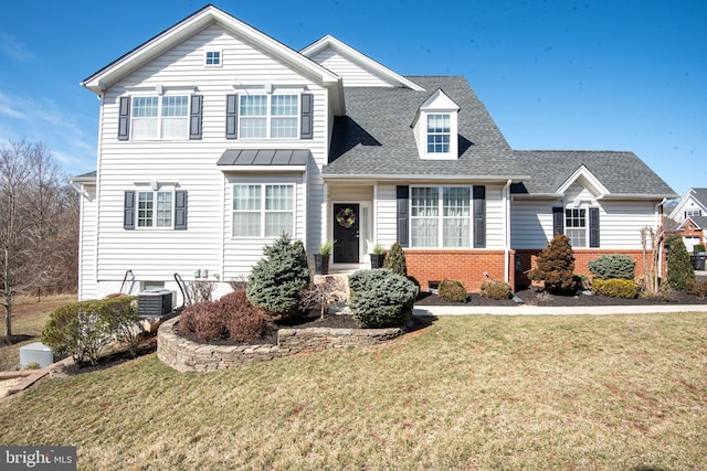 traditional-style home featuring a front lawn, brick siding, and a shingled roof