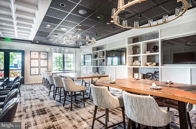 dining space with visible vents, beam ceiling, ornamental molding, coffered ceiling, and baseboards