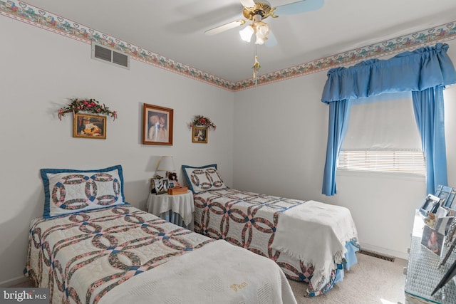 carpeted bedroom featuring visible vents, baseboards, and ceiling fan