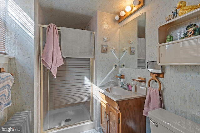 full bath with toilet, a stall shower, vanity, and radiator heating unit