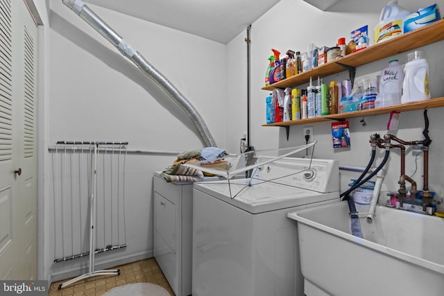 laundry room with a sink, separate washer and dryer, and laundry area