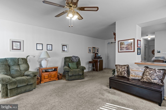 carpeted living room with ceiling fan