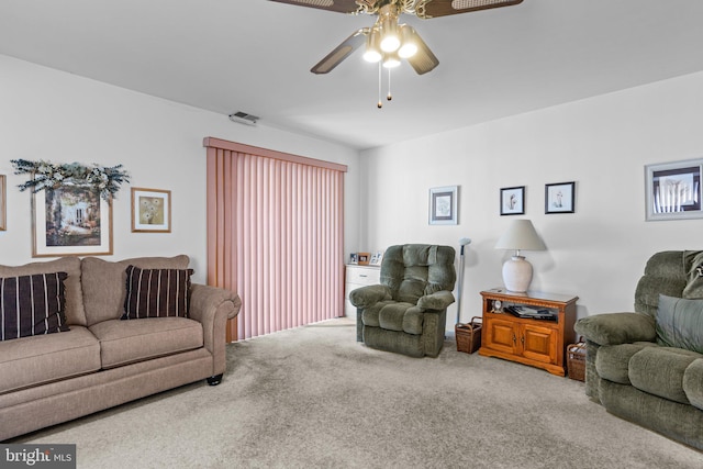 living area with a ceiling fan, carpet, and visible vents