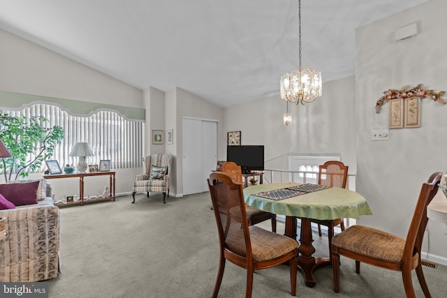 dining area with plenty of natural light, carpet flooring, an inviting chandelier, and vaulted ceiling