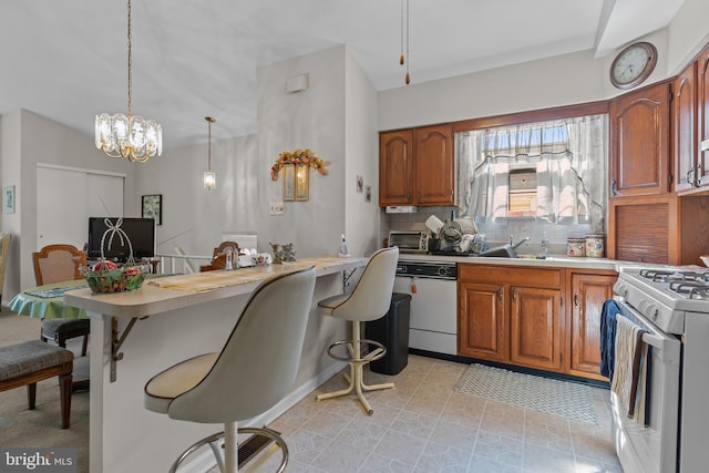 kitchen with decorative backsplash, white appliances, a breakfast bar, and light countertops