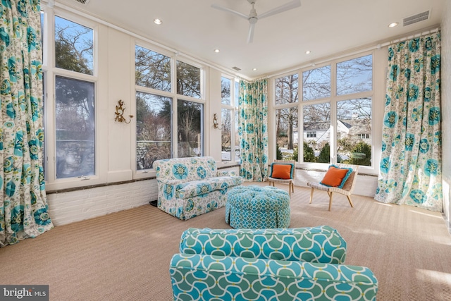 sunroom featuring visible vents and a ceiling fan