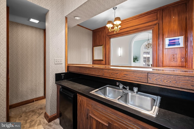 kitchen featuring dark countertops, dishwasher, wallpapered walls, and a sink