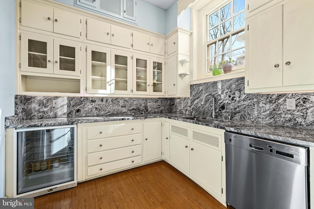 kitchen with a sink, backsplash, beverage cooler, dishwasher, and dark wood-style flooring