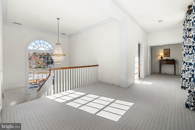 hallway with crown molding, carpet flooring, visible vents, and a chandelier