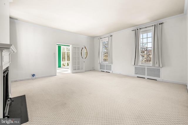 unfurnished living room featuring baseboards, a fireplace with flush hearth, carpet floors, and radiator heating unit