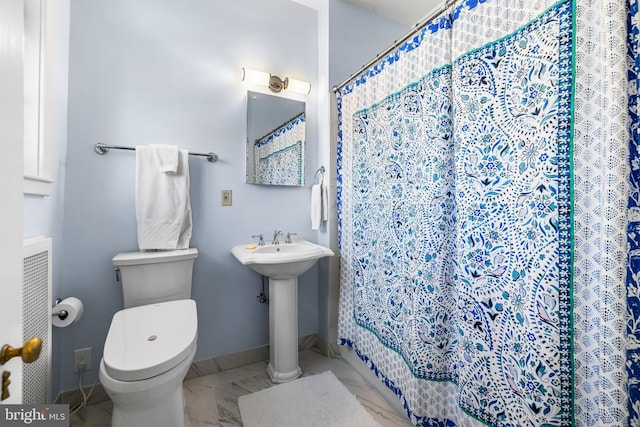 bathroom with curtained shower, baseboards, toilet, marble finish floor, and a sink