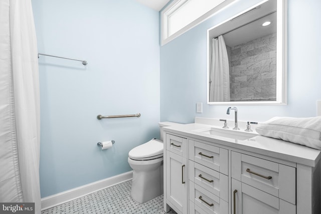 full bathroom with toilet, vanity, and baseboards