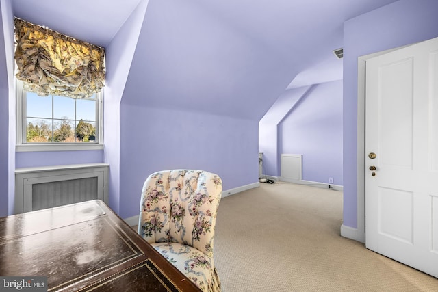 office space with visible vents, baseboards, carpet, and vaulted ceiling