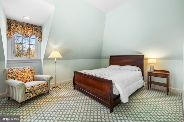 bedroom with vaulted ceiling, baseboards, and carpet floors