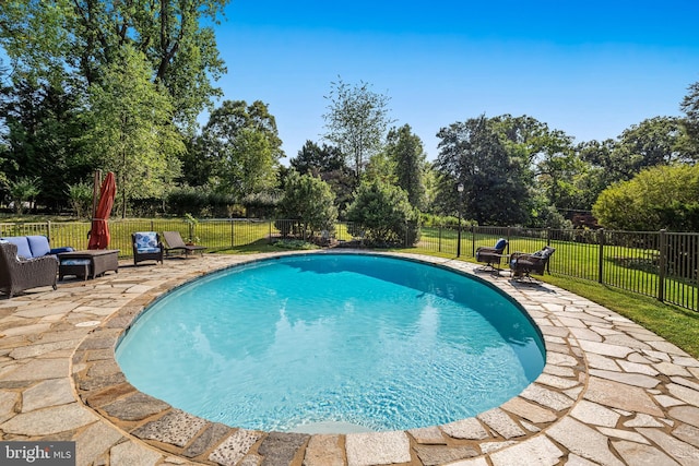 view of pool featuring a patio area, a lawn, a fenced backyard, and a fenced in pool